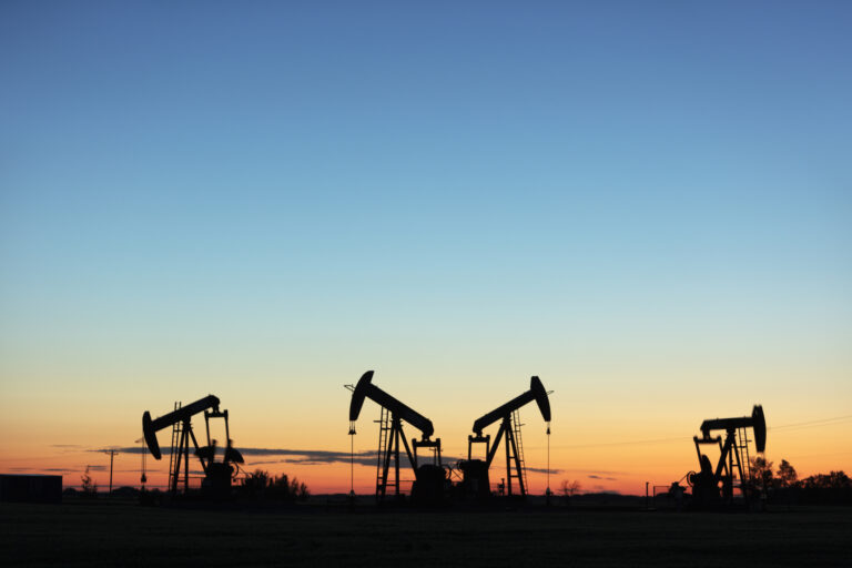 Four pump jacks producing oil, Image taken near the town of Virden, Manitoba. Image taken from a tripod.