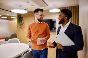 Outsourced Controllers walking and talking in modern office